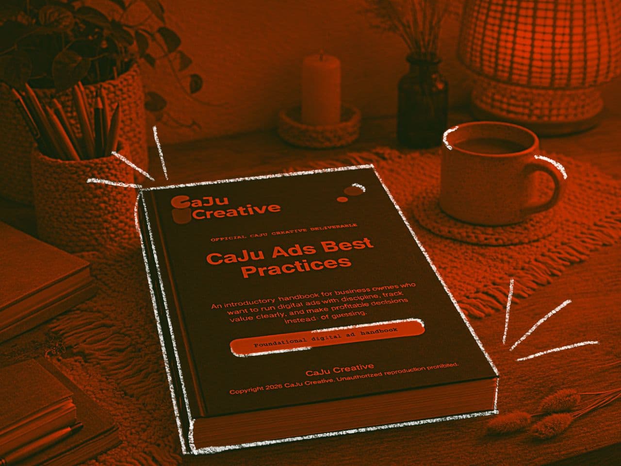 Orange-toned visual of a CaJu Creative consulting handbook on a desk